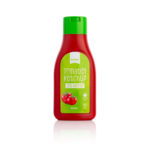 Keto Ketchup w czerwonym opakowaniu z zieloną etykietą i nakrętką.
